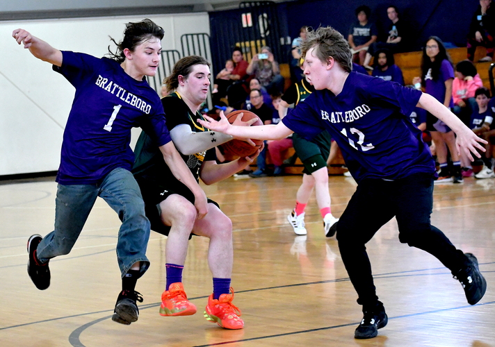 Brattleboro’s Austin Pinette (1) and Ben Stauffer (12) try to slow down Burr & Burton’s Dylan Skandera (40) during second half action in their Unified basketball playoff game on May 18 in the BUHS gym.