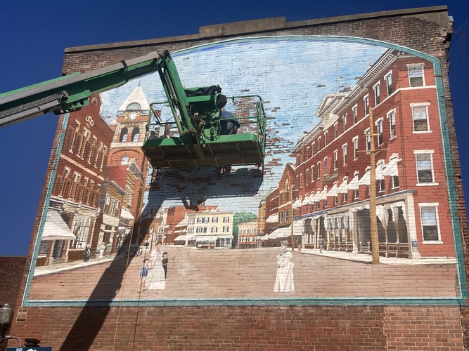 Repairs have begun on the mural that was painted in 1999 on the Flatiron Building in Bellows Falls.
