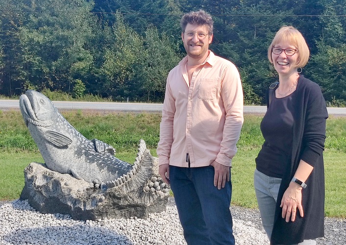Scultptor Sean Hunter Williams, left, and State Rep Sara Coffey, D-Guilford, stand with his sculpture that was installed in 2020 at the Roxbury Fish Hatchery with funding through the Art and State Buildings program.
