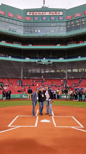 From left, Kate Boudreau, (daughter) Joan Martin, Gregg Thompson, and Devin Thompson (on Gregg’s back) stand behind home plate last week at Fenway Park in Boston.