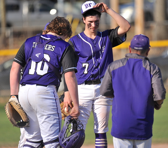 Bellows Falls starting pitcher Eli Allbee, center, gets ready for a mound visit from coach Bob Lockerby, right, as catcher Jake Moore looks on during the third inning of their game against Brattleboro on April 13 at Hadley Field.