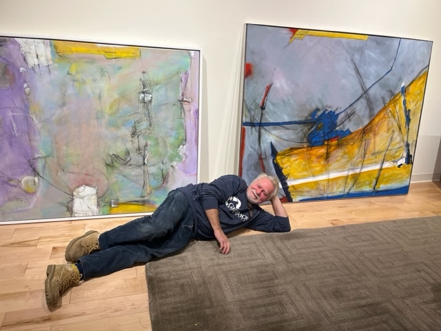 Artist Dan Welden poses with “Tony Baloney” and “Monk’s Yoga,” two mixed-media works from his show “Dan Welden: Solo 100,” which runs from Oct. 21 until Jan. 14, 2024 at Mitchell-Giddings.