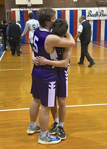 Bellows Falls forward Caden Haskell (5) consoles teammate Walker James following their team’s 71-51 loss to Winooski in the Division III state boys’ basketball semifinal on March 9 at the Barre Auditorium.