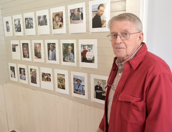 Photographer Chuck Fish stands in front of some of the photos that make up the &#8220;Faces of Dummerston&#8221; exhibit, which opens on June 11 at the Dummerston Historical Society.