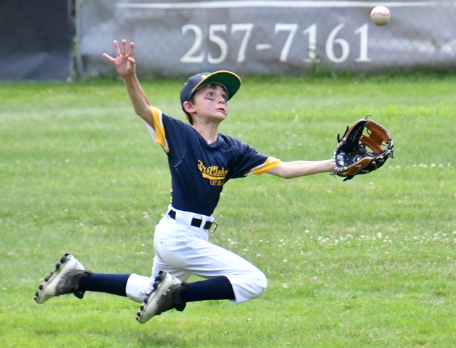 Brattleboro left fielder Teddy McKay stretches out to catch a fly ball hit by Rutland’s Lane Lubaszewski in the fifth inning of the first game of their Little League 10-U District 2 championship series on July 15 at South Main Street Field.