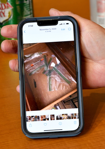 Brattleboro landlord Susan Bellville shows a cell phone photo of a drawer full of used needles and drug paraphernalia found in a vacated apartment.