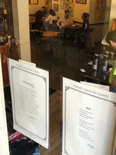 Two poems from this year’s batch of Poetry Around Town are displayed in the window of Mocha Joe’s on Main Street in Brattleboro.