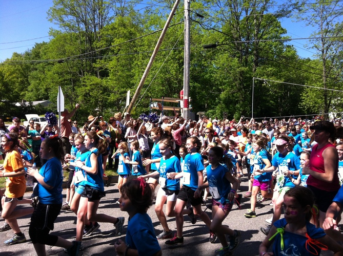 Some of the 1,700 girls entered in the annual Girls on the Run 5K Run/Walk pass the starting line in 2012.