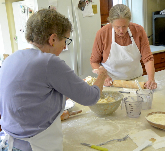 Bess Richardson, left, and Eliza Greenhoe-Berg make and fill pie crusts last week in the basement kitchen of Dummerston Congregation Church.