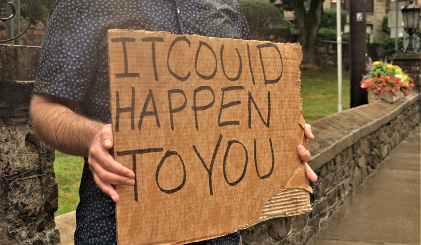Amid flaring tempers about homelessness and panhandling, a participant holds a sign at a 2019 rally in downtown Brattleboro.