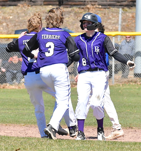 Bellows Falls baserunner Trenton Fletcher (8) is greeted by teammates after he hit a two-run double to win the Terriers’ season opener, 2-1, over Otter Valley on April 8 at Hadley Field.