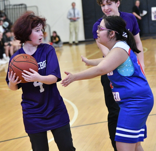 Brattleboro’s Faith Rowe (4) protects the ball as two Hartford defenders move in during the first half of their Unified basketball game on May 1 at the BUHS gym.