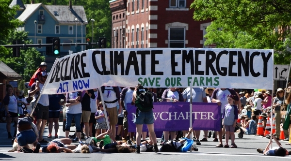 Adult climate activists in the parade cheer for the kids