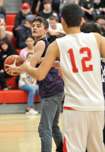 Brattleboro’s Austin Pinette, left, looks for an open teammate to pass to during first-half Unified basketball action against Twin Valley on April 11 in Whitingham.