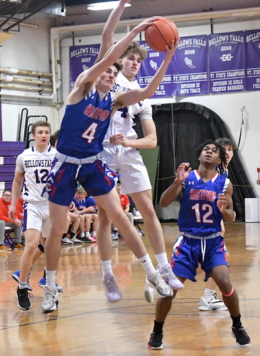 Hartford’s Christian Hathorn (4) pulls down a rebound in front of Bellows Falls defender Jesse Darrell during first half boys’ basketball action on Jan. 20 at Holland Gymnasium. Looking on are Jaxon Clark of Bellows Falls (12) and Hartford’s Ayodele Lowe (12).