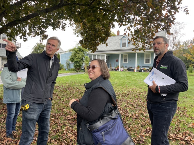 From left, Matthew Littell of Utile Architecture & Planning, Bellows Falls resident Dalila Hall, and local developer John Dunbar discuss building missing middle housing on Hall’s residential lot in Bellows Falls during a Oct. 18 tour convened by the Vermont Agency of Commerce and Community Development.