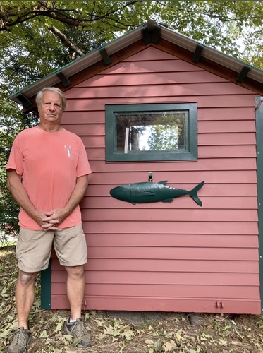 Steve Haisley of Putney stands beside his award-winning ice fishing shack.