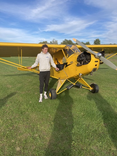 Ben Burg with the 1946 Piper Cub, in which he made his first solo flight in 2022.